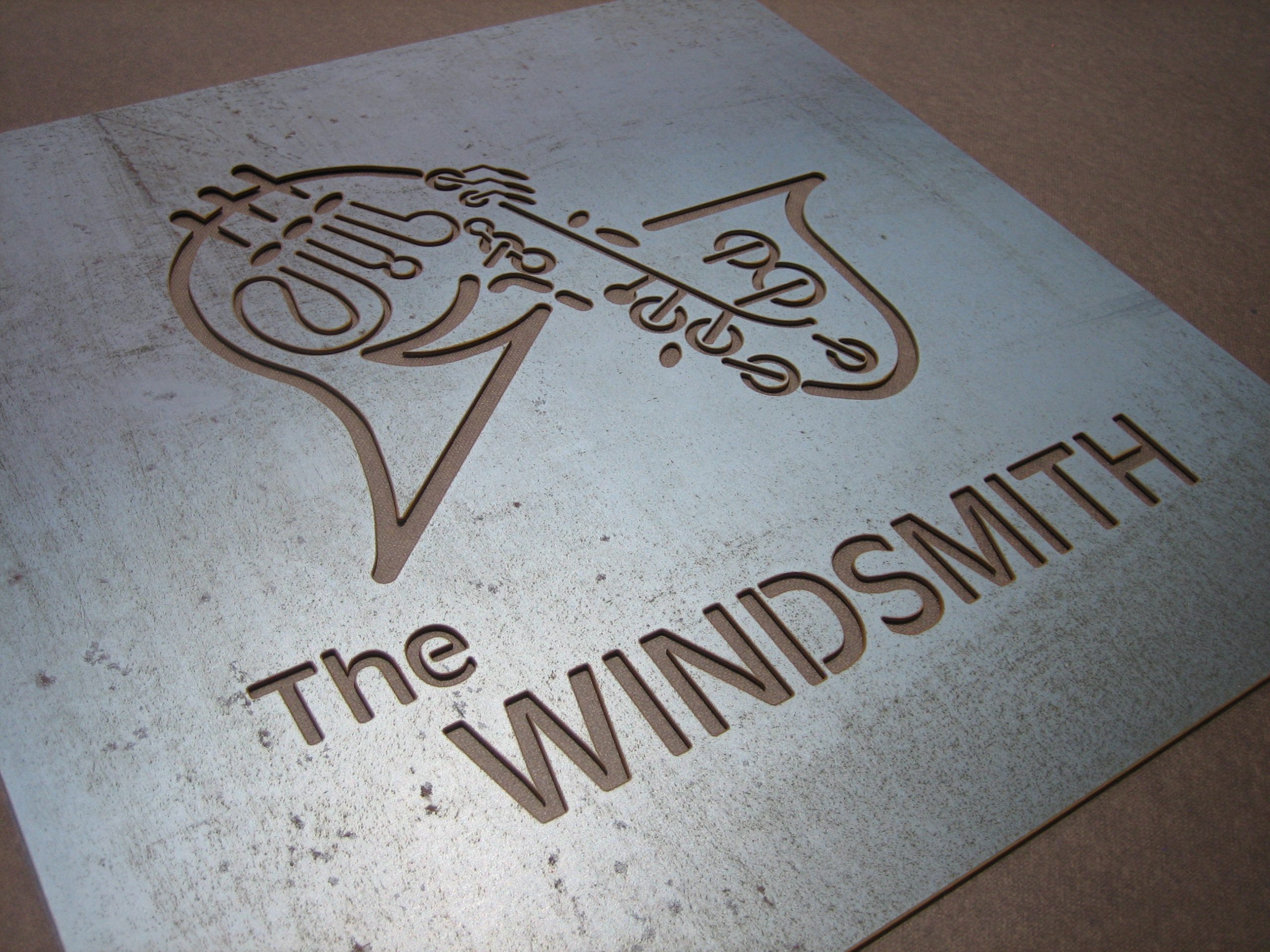 colorado_waterjet_company_signs_sculptures_the_windsmith High-Volume Production Jobs – metal tabs